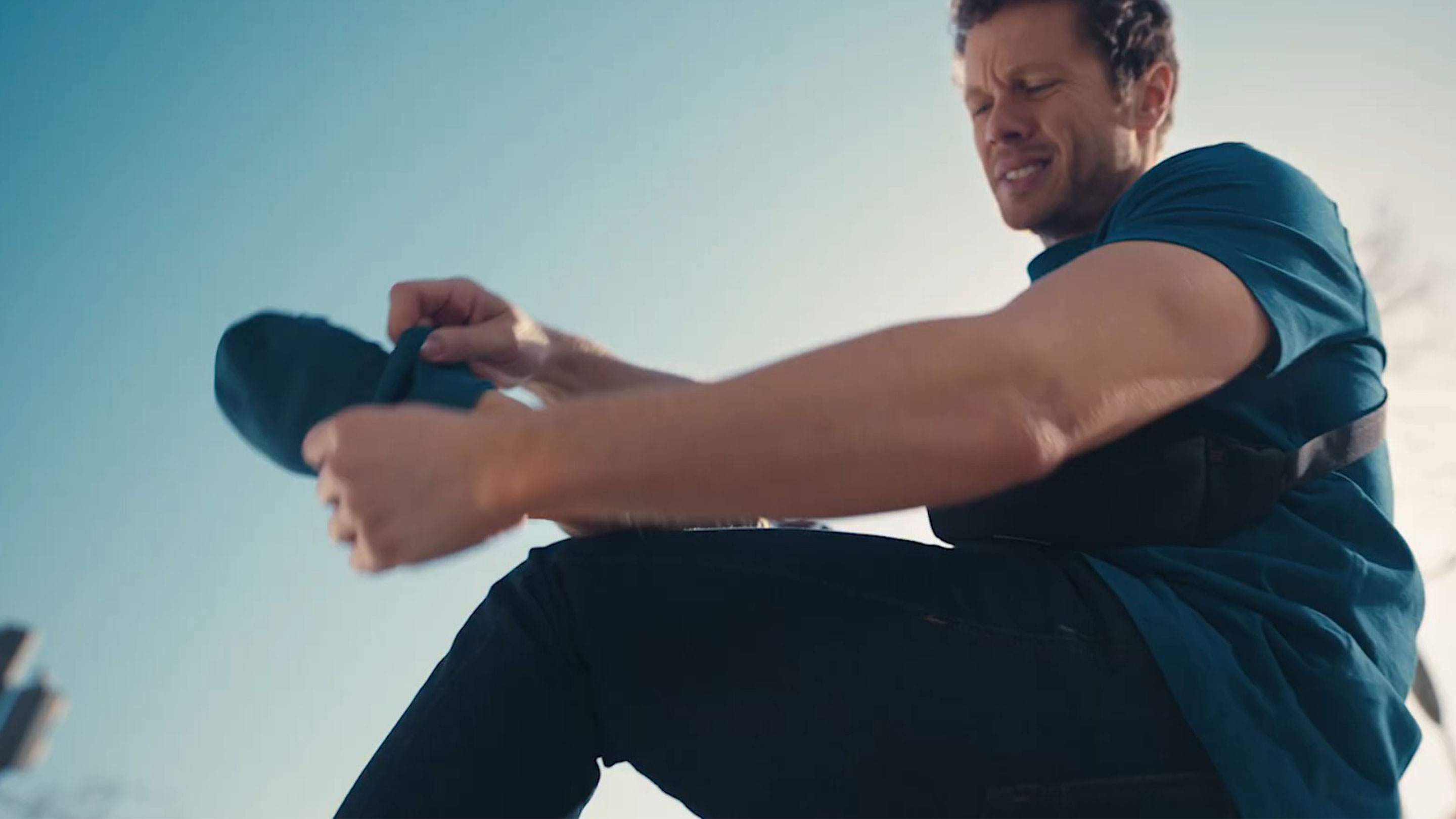 Man taking off his socks with painful expression
